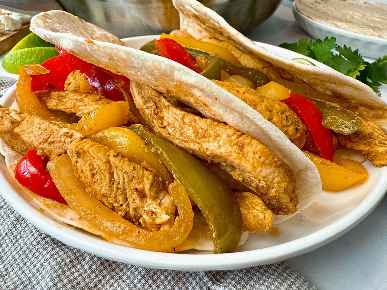 chicken and bell peppers in tortillas to make fajitas
