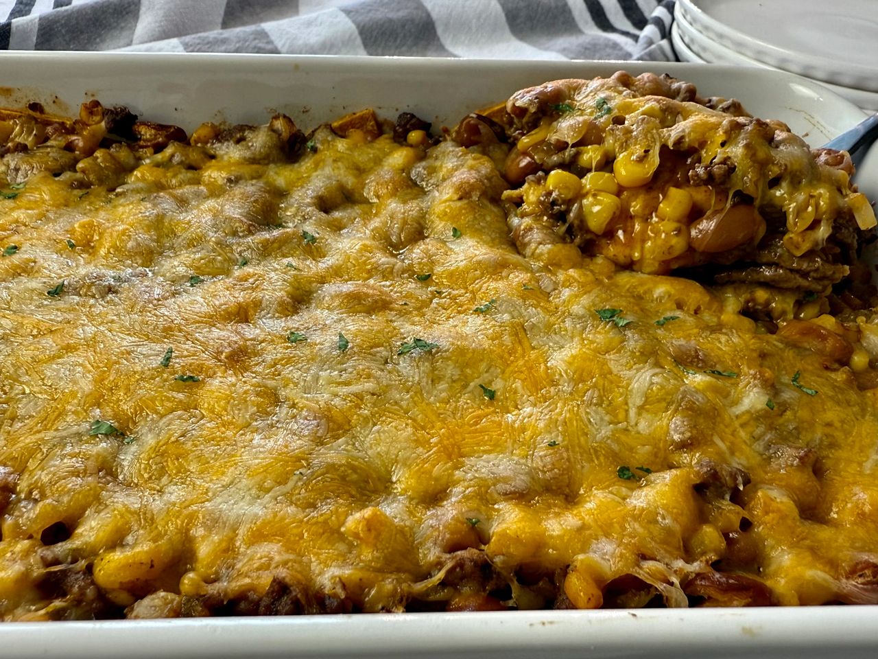 enchilada casserole in a white baking dish