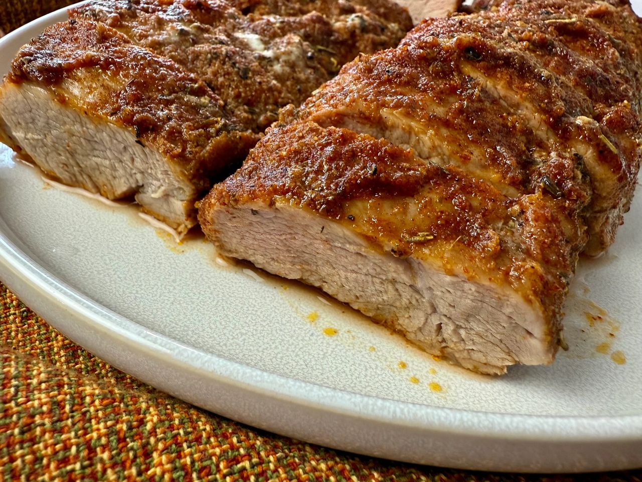 sliced pork tenderloin on a white plate