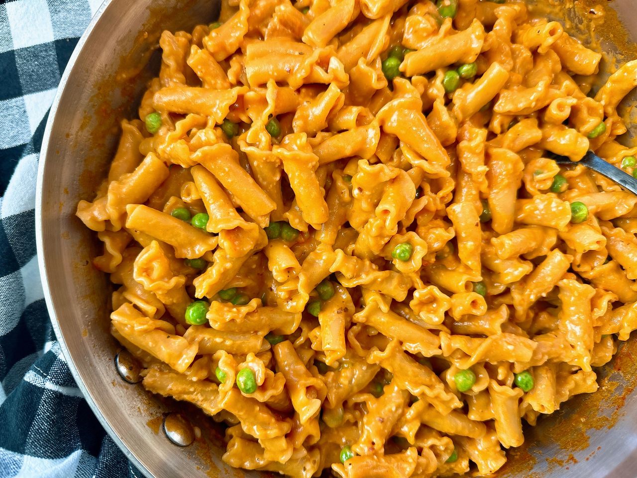 pasta and peas in a white bowl