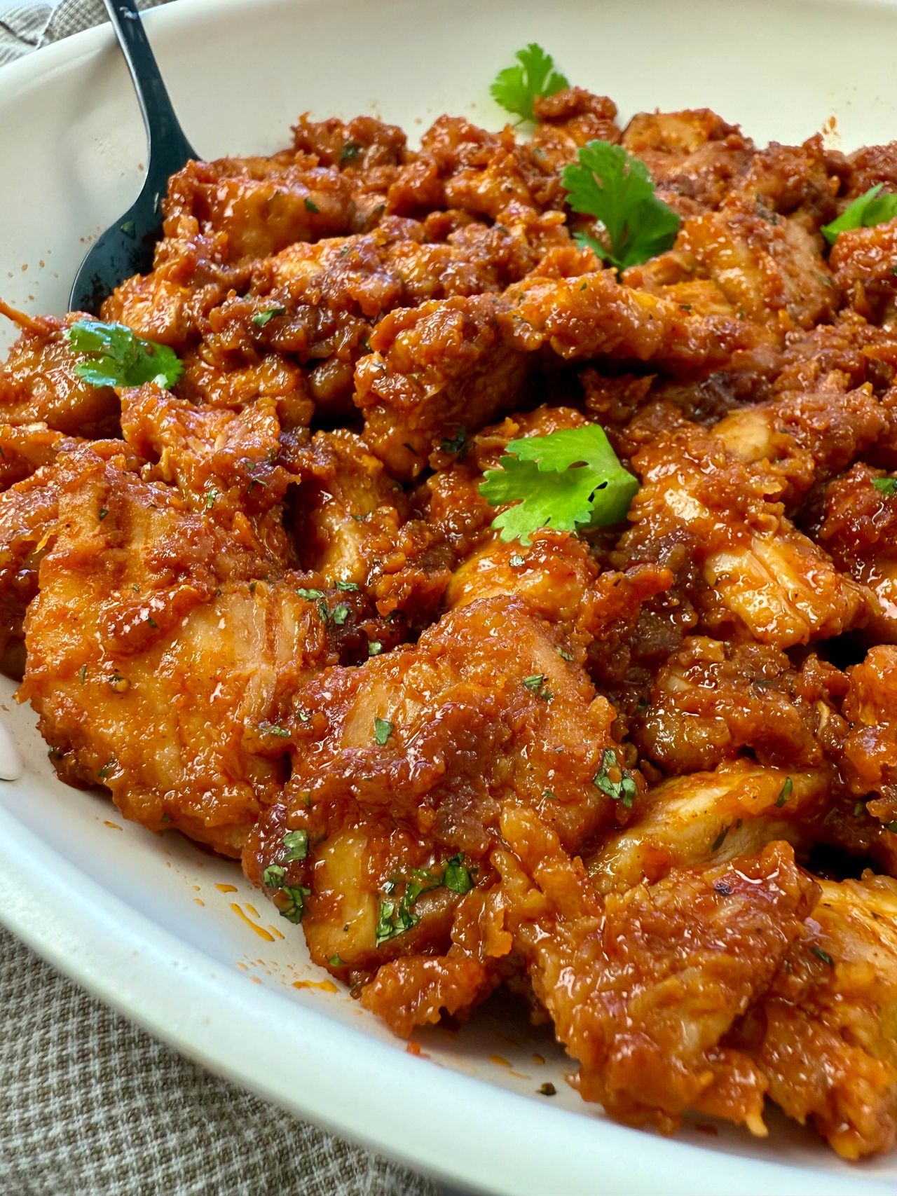 gochujang chicken in a white skillet