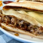 philly cheesesteak on a white plate