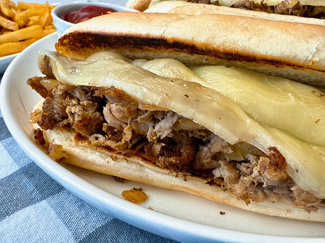 Philly Cheesesteaks philly cheesesteak on a white plate