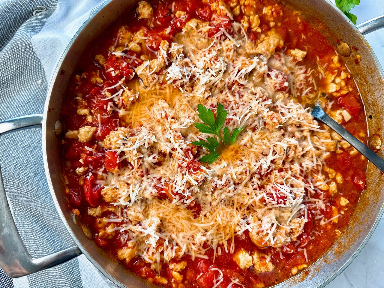 ground chicken arrabbiata with cheese in a silver pan