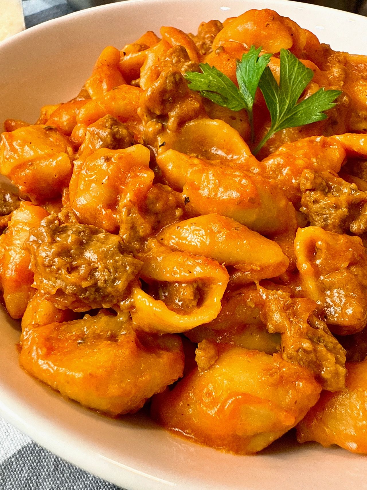 bowl of pasta and beef with a spoon