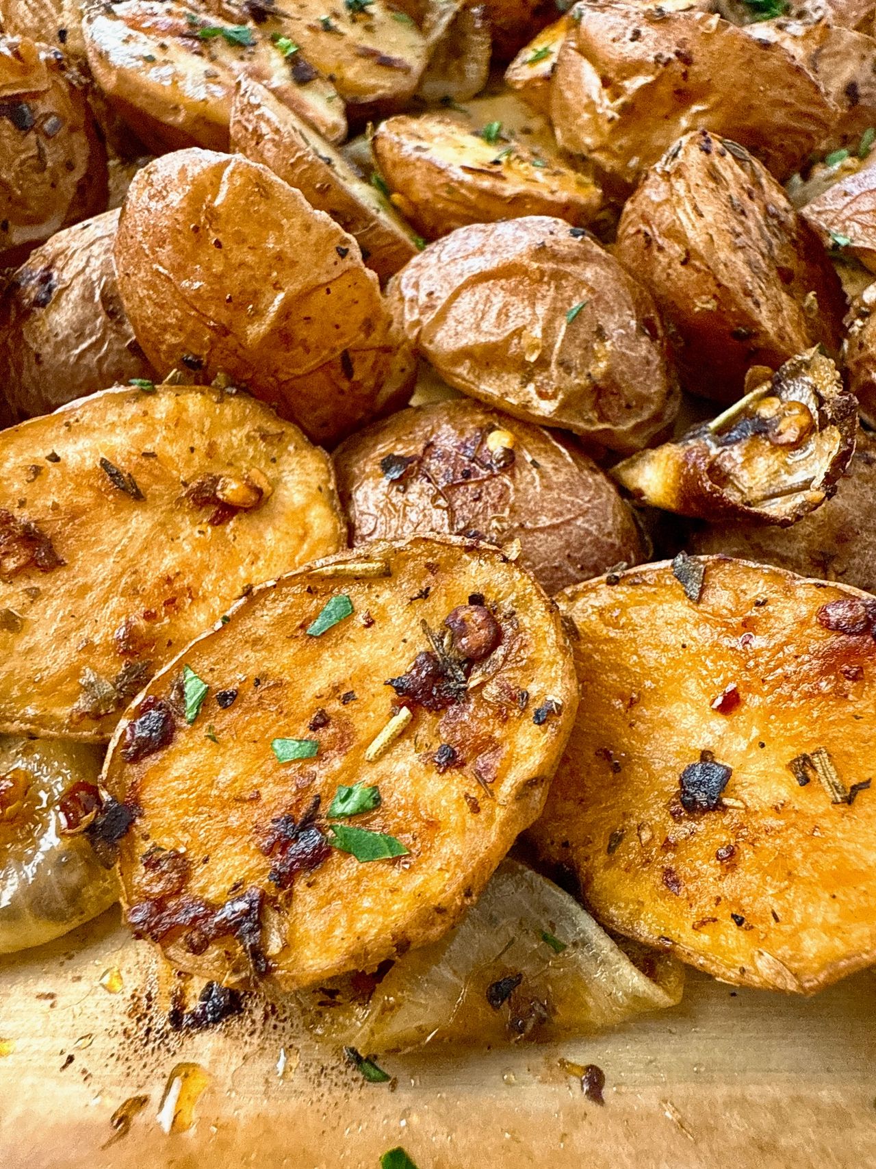 garlic roasted potatoes and onions on a baking sheet
