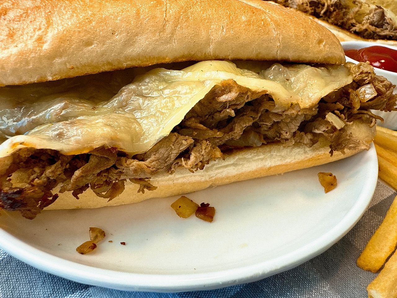 philly cheesesteak on a white plate