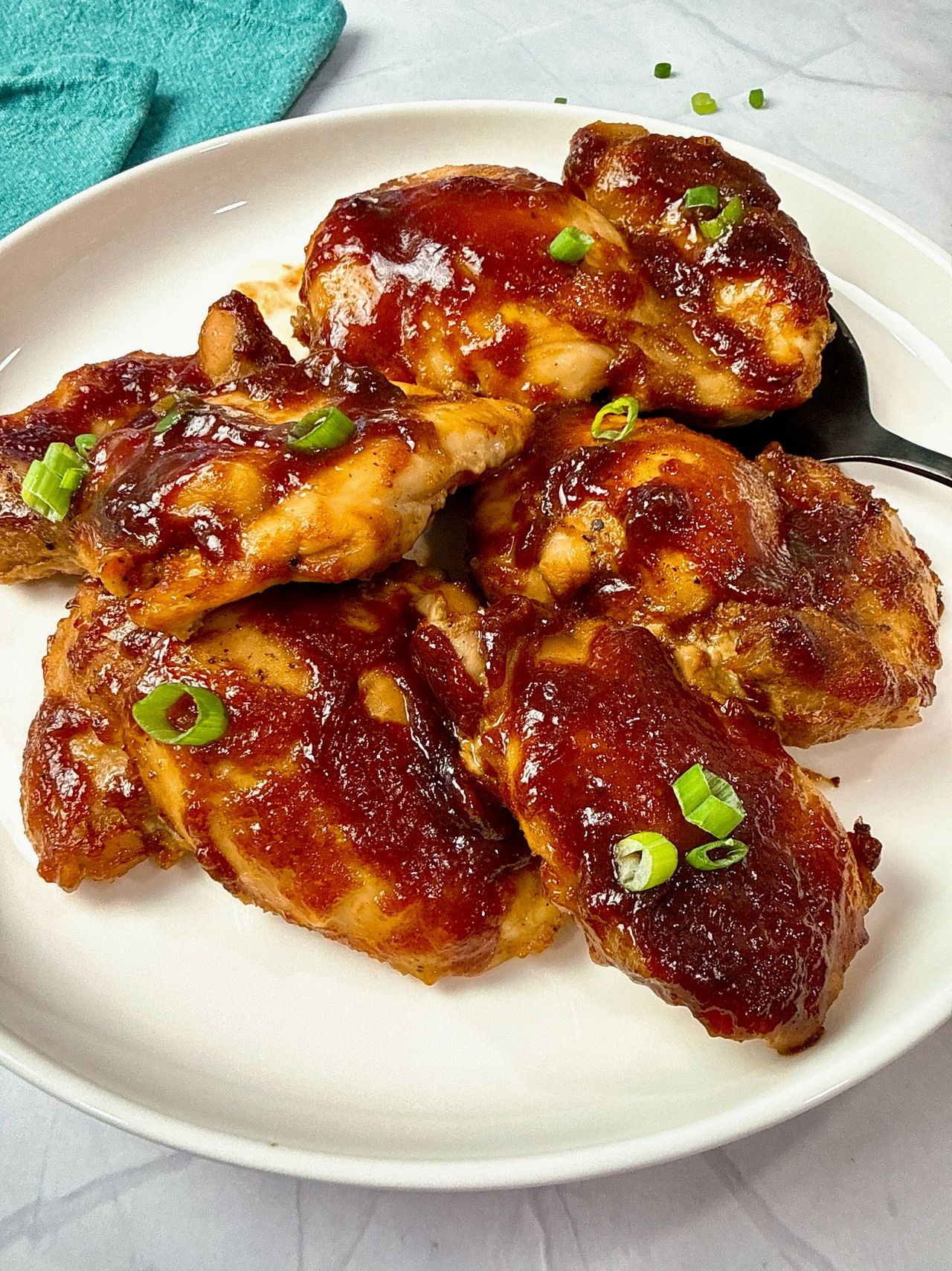 chicken thighs with glaze on a white plate