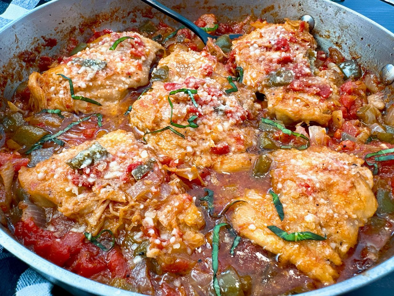 chicken thighs and vegetables in a skillet