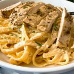 chicken alfredo in a white bowl