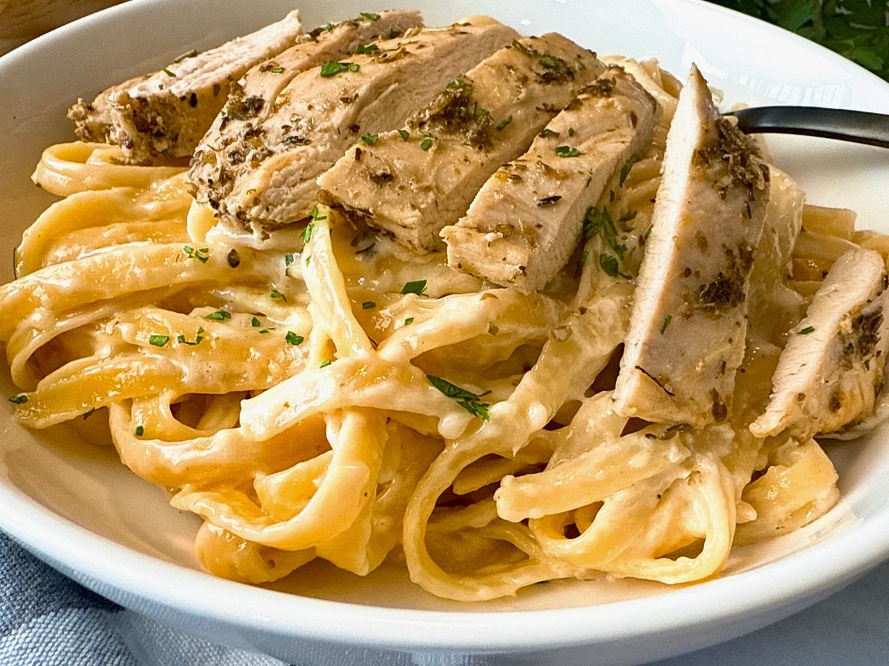 Chicken Alfredo chicken alfredo in a white bowl