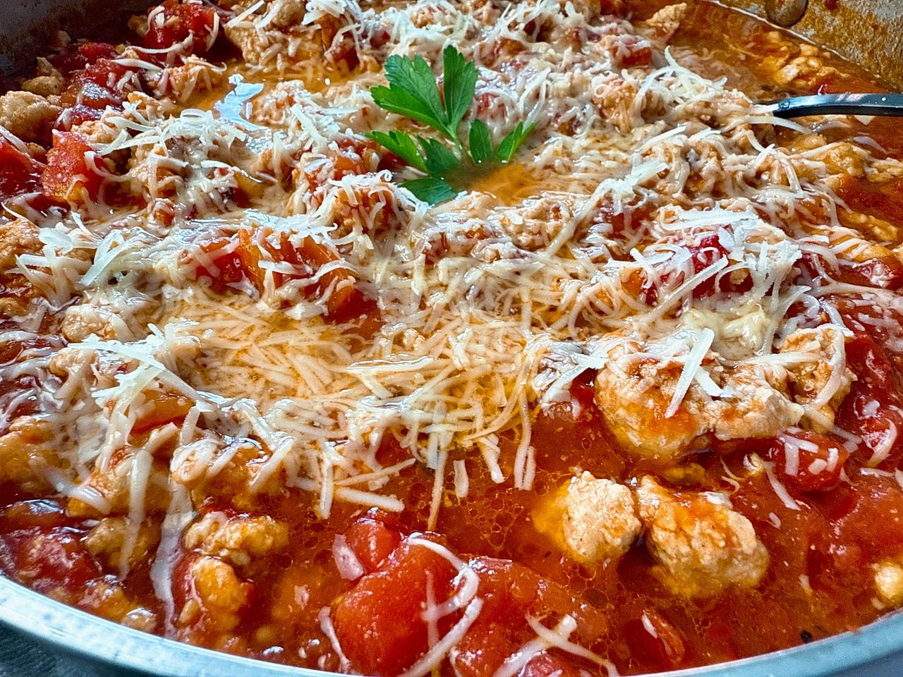 ground chicken arrabbiata with cheese in a silver pan