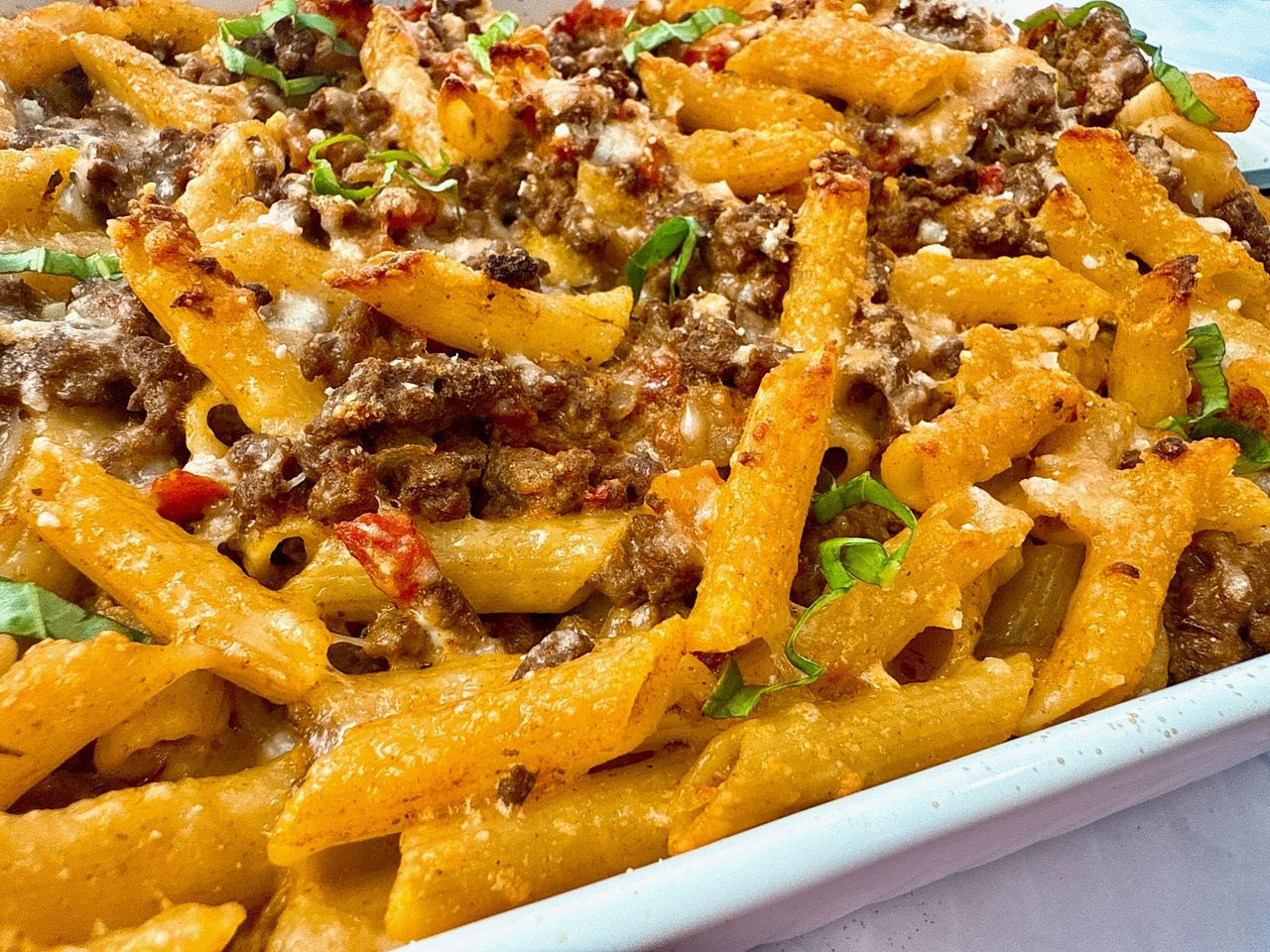 pasta and beef in a white baking dish