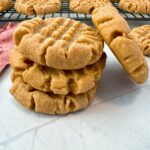 stacked peanut butter cookies on a white background