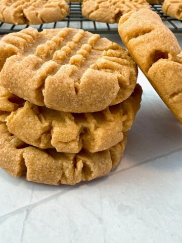 stacked peanut butter cookies on a white background