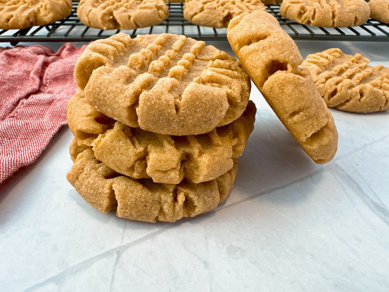 stacked peanut butter cookies on a white background