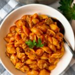 bowl of pasta and beef with a spoon