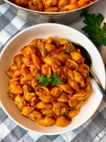 bowl of pasta and beef with a spoon