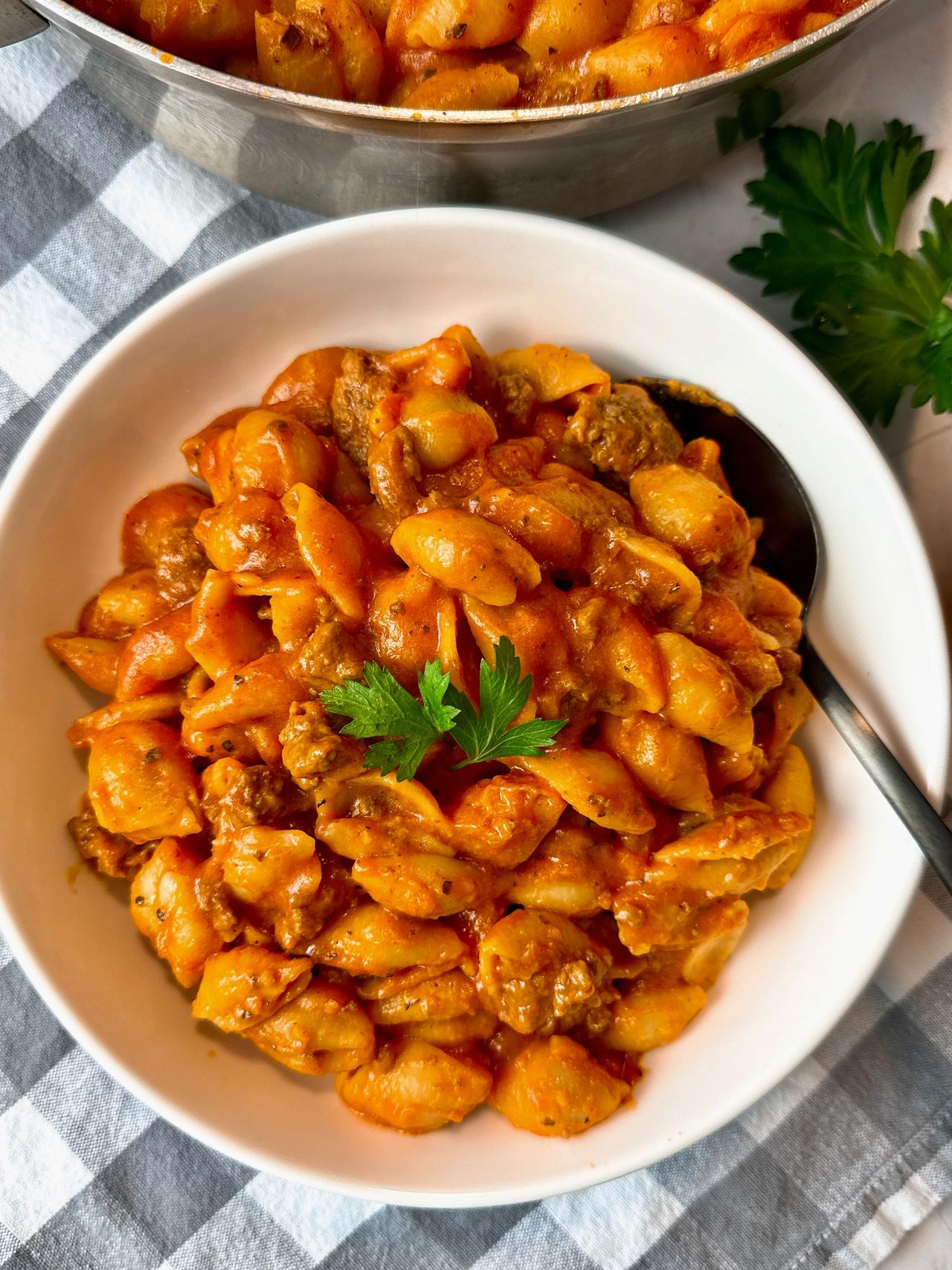bowl of pasta and beef with a spoon