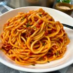 pasta amatriciana in a white bowl