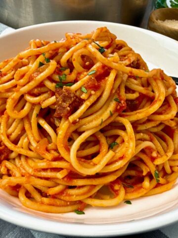 pasta amatriciana in a white bowl