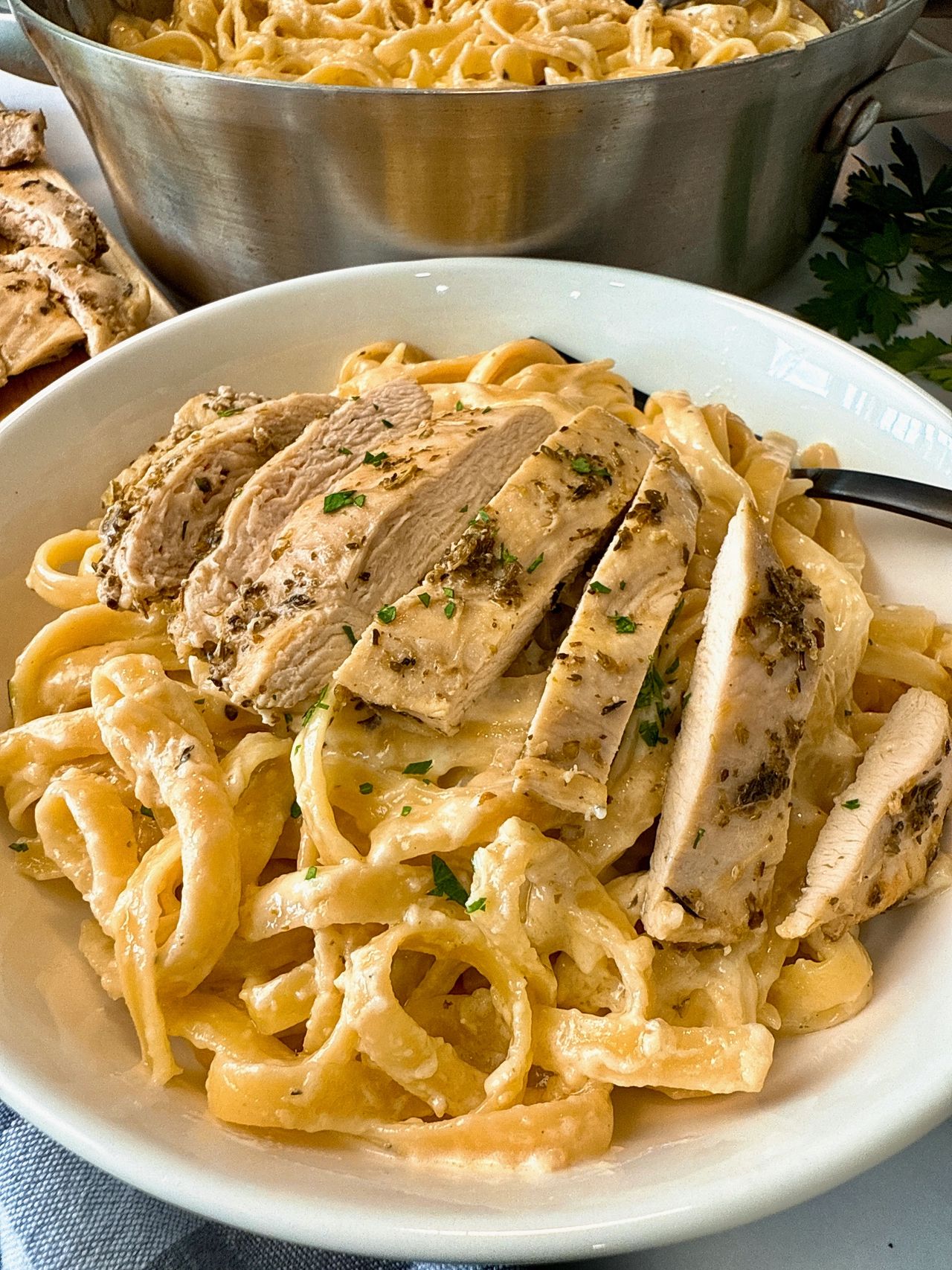 chicken alfredo in a white bowl