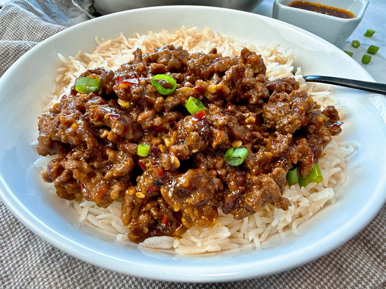 Chili Crisp Ground Beef Ground beef and chili crisp over rice in a white bowl