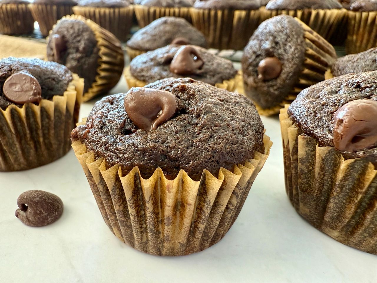 mini chocolate banana muffins on a white surface
