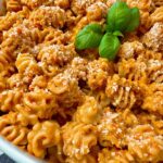 radiatori pasta with roasted red pepper sauce in a white bowl
