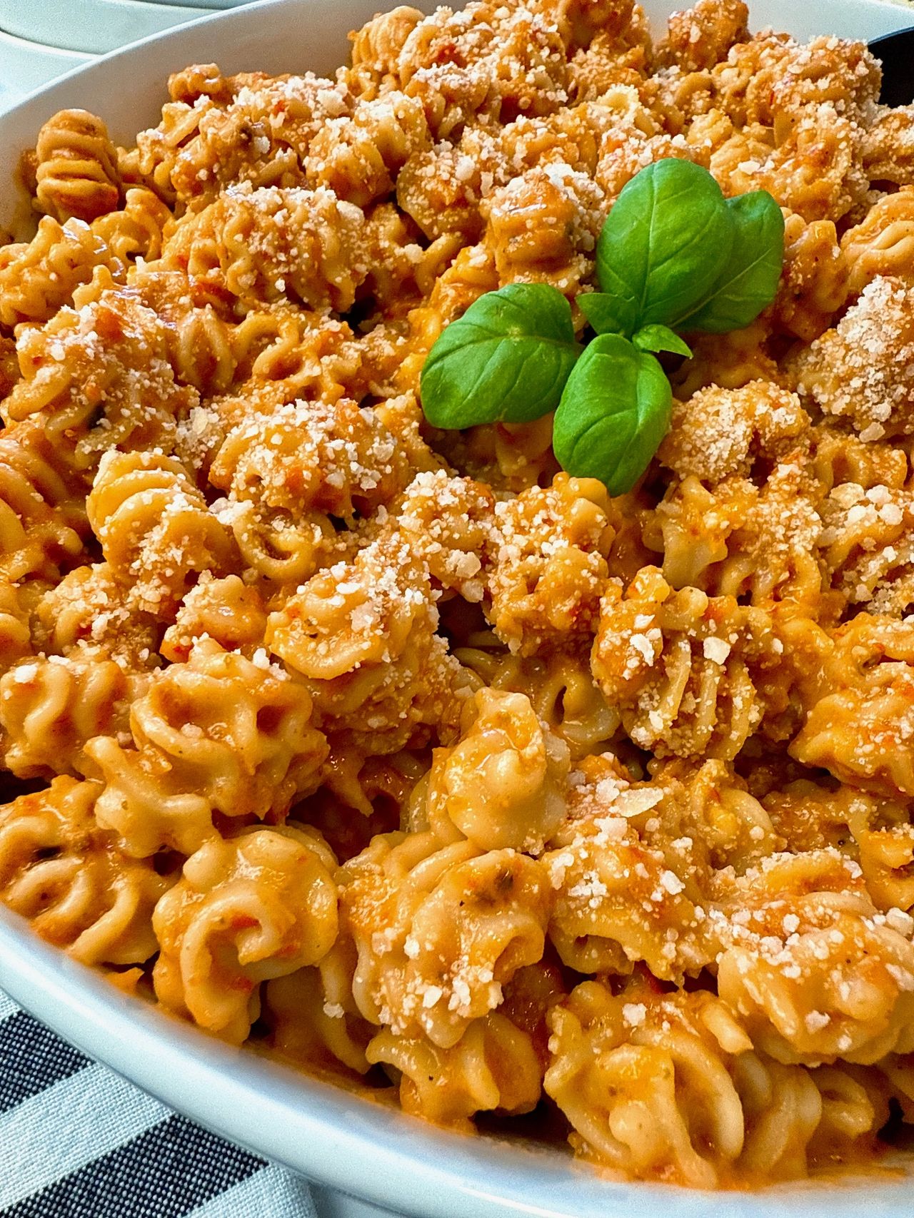 radiatori pasta with roasted red pepper sauce in a white bowl