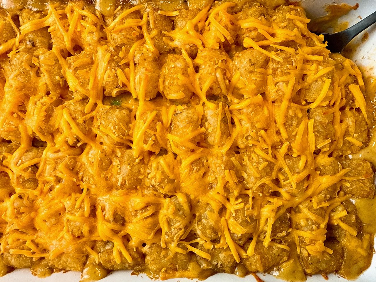 tater tot casserole in a white baking dish