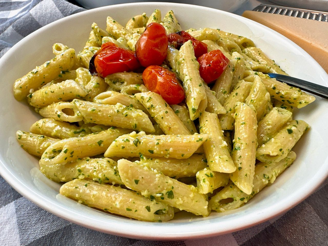 penne pasta with pesto and blistered tomatoes