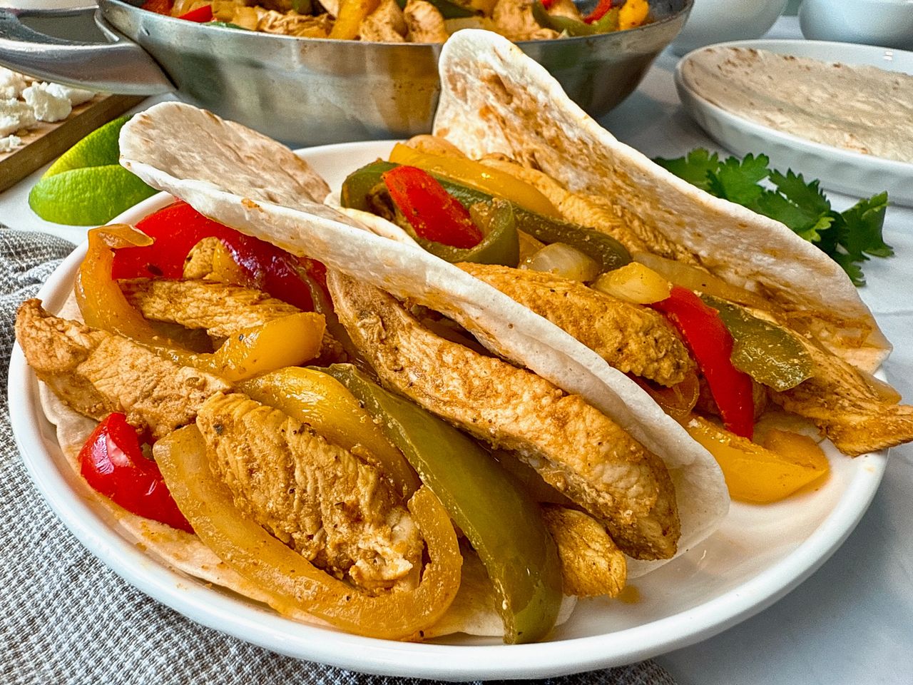 chicken and bell peppers in tortillas to make fajitas