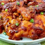 gochujang chicken thighs on a white plate