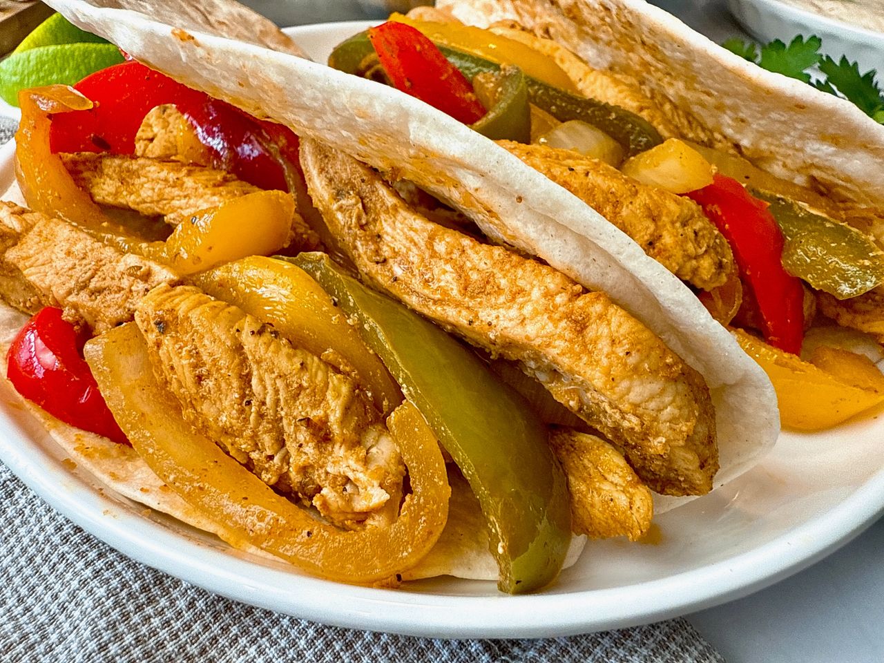 chicken and bell peppers in tortillas to make fajitas