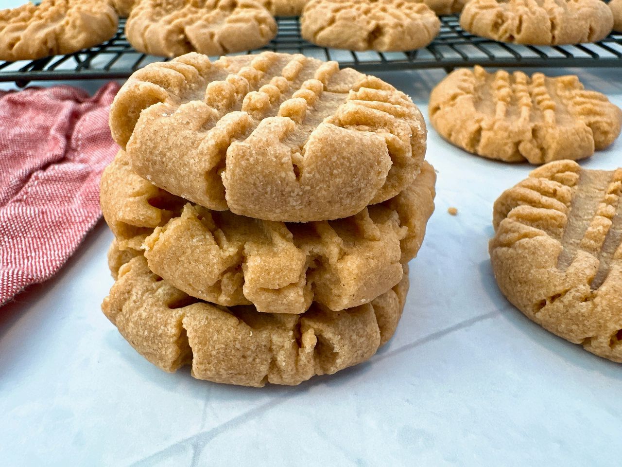 stacked peanut butter cookies on a white background