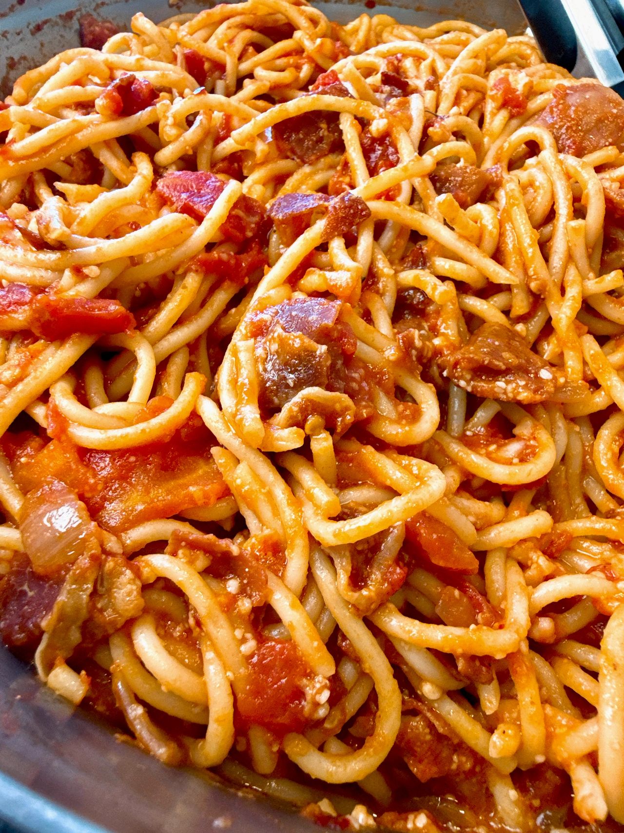 pasta amatriciana in a white bowl