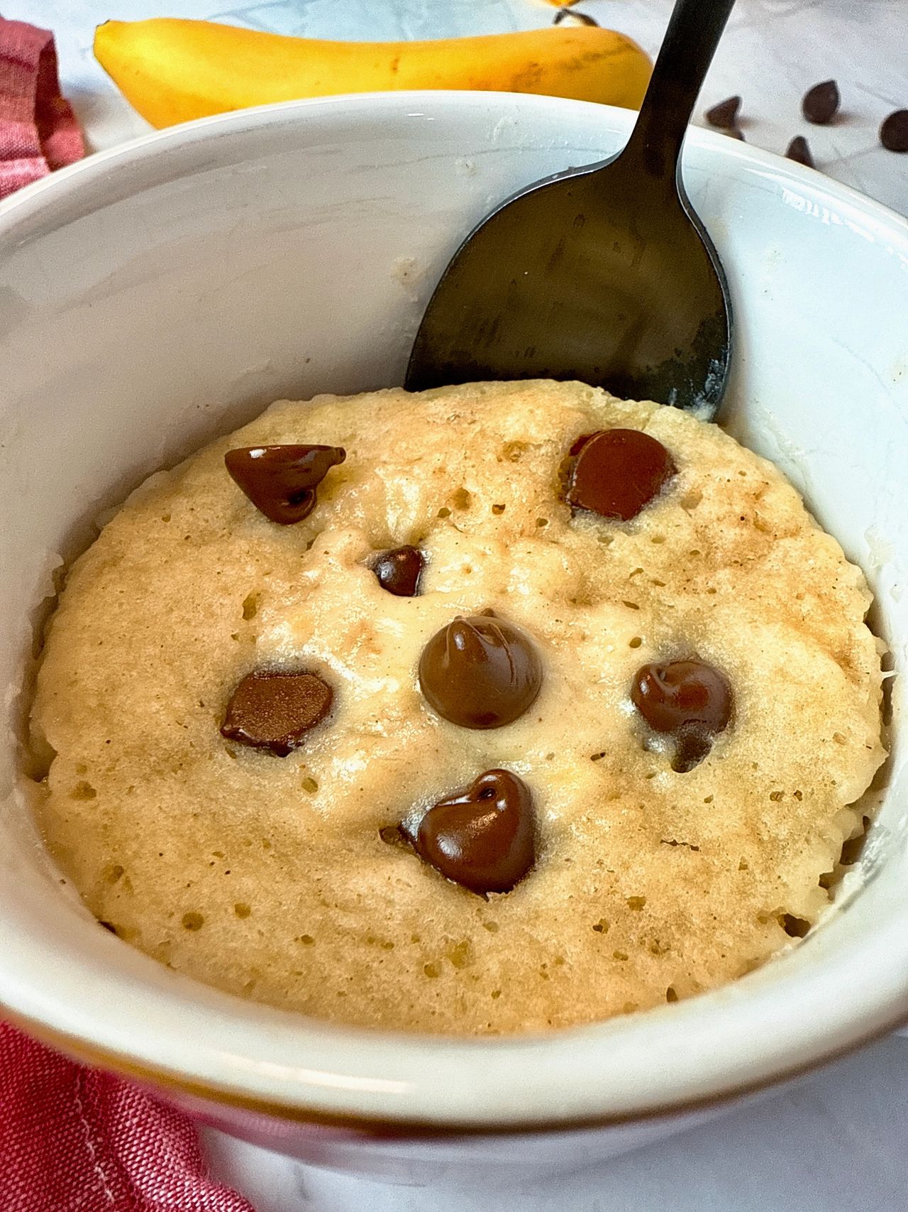 chocolate chip banana bread mug cake with a spoon