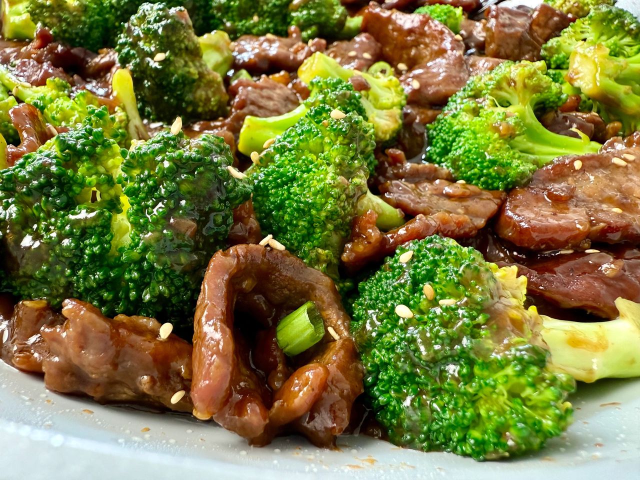 beef and broccoli in a white skillet
