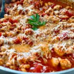 ground chicken arrabbiata with cheese in a silver pan