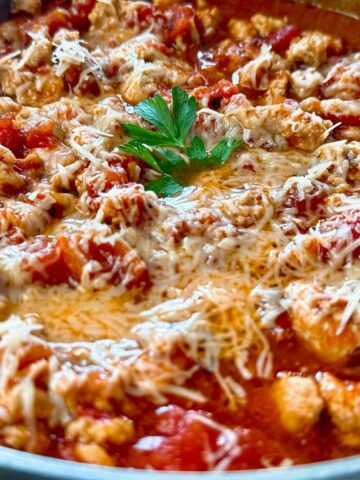 ground chicken arrabbiata with cheese in a silver pan