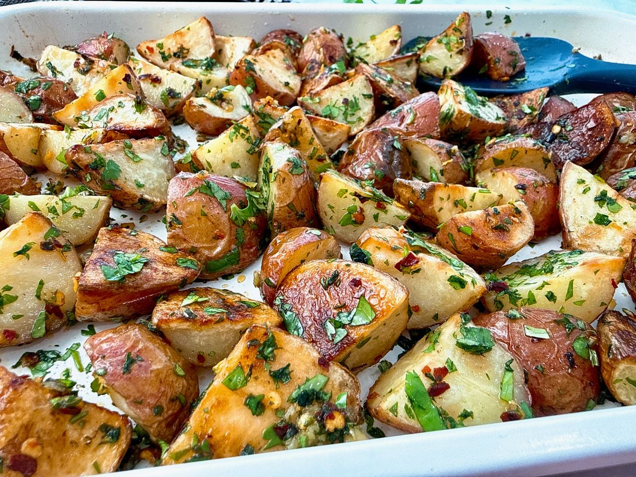 roasted potatoes on a white baking sheet