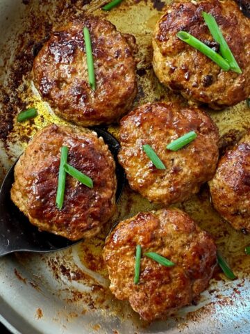 polish sausage on a spoon in a skillet