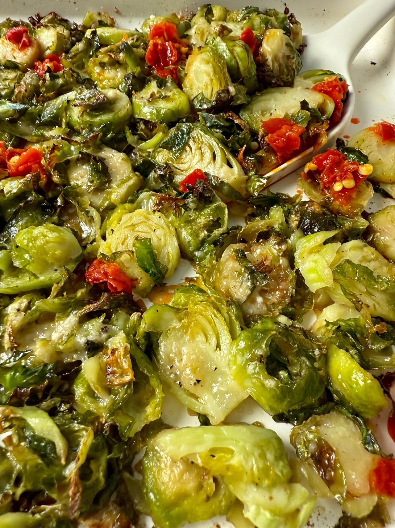 Shaved Brussels Sprouts with Calabrian Peppers on a white baking pan