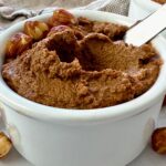 hazelnut spread in a white ramekin with a butter knife
