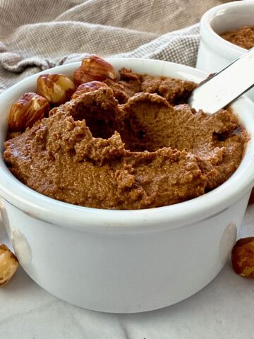 hazelnut spread in a white ramekin with a butter knife