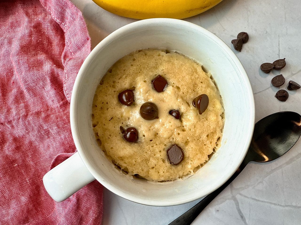 chocolate chip banana bread mug cake with a spoon