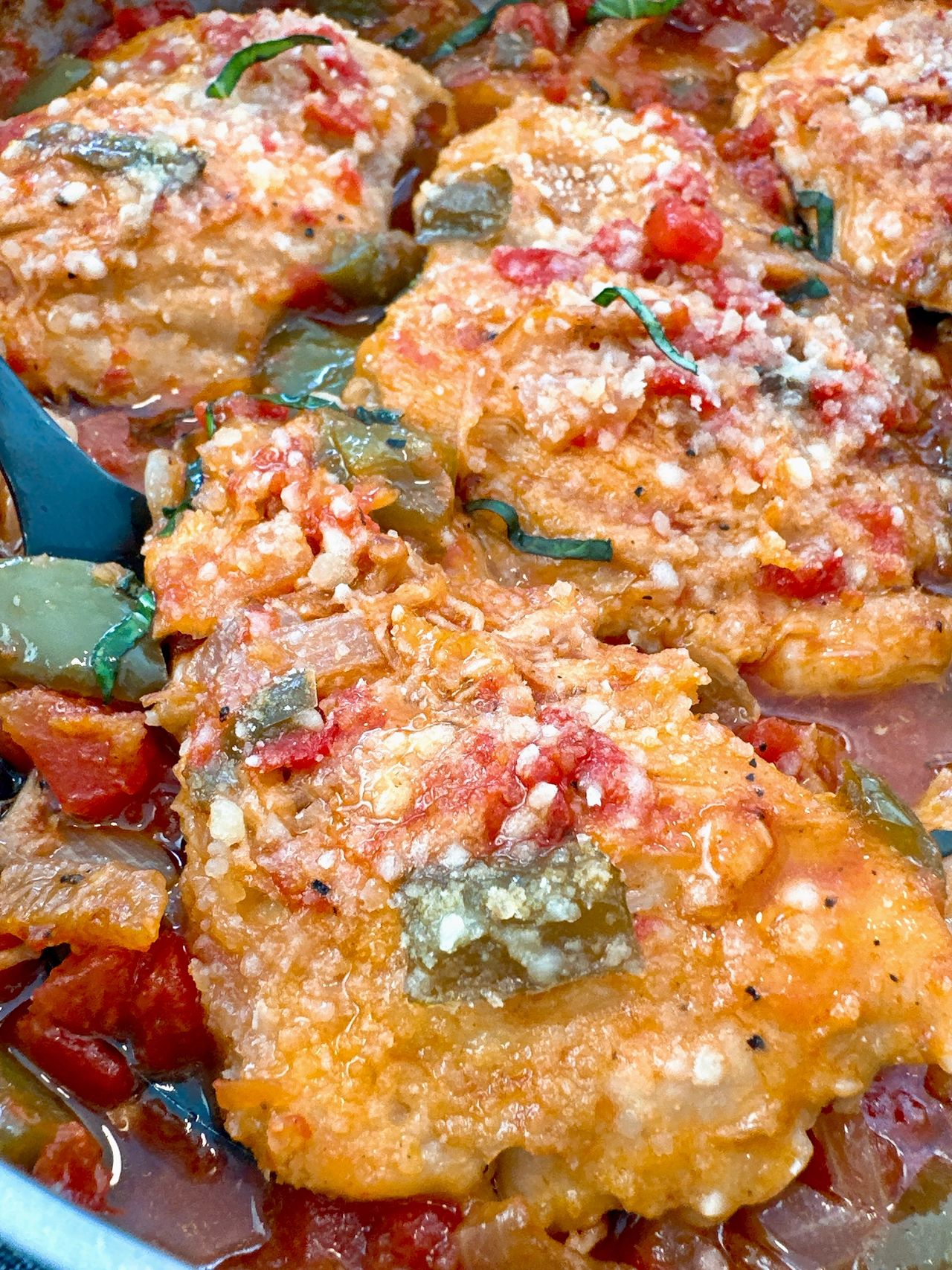 chicken thighs and vegetables in a skillet