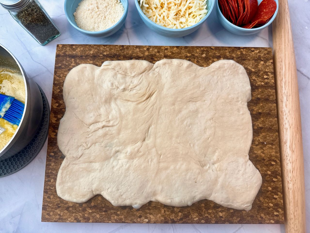 bread dough rolled out on a cutting board