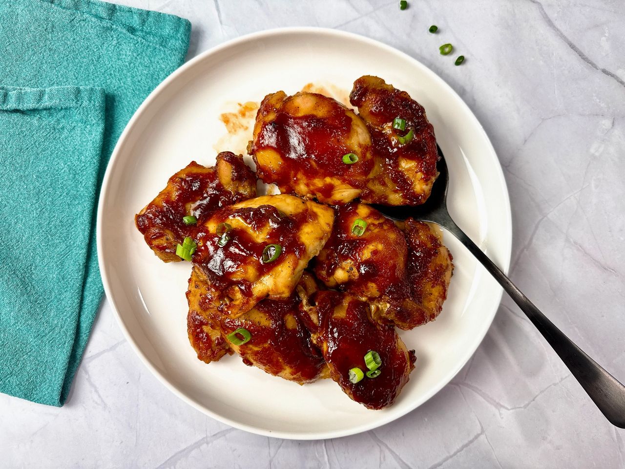 chicken thighs on a white plate